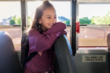 Smiling student on school bus