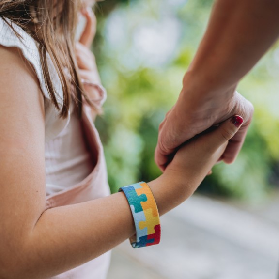 Child and parent holding hands