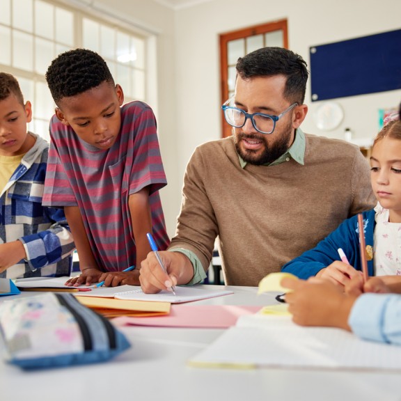 Students going over lesson with teacher