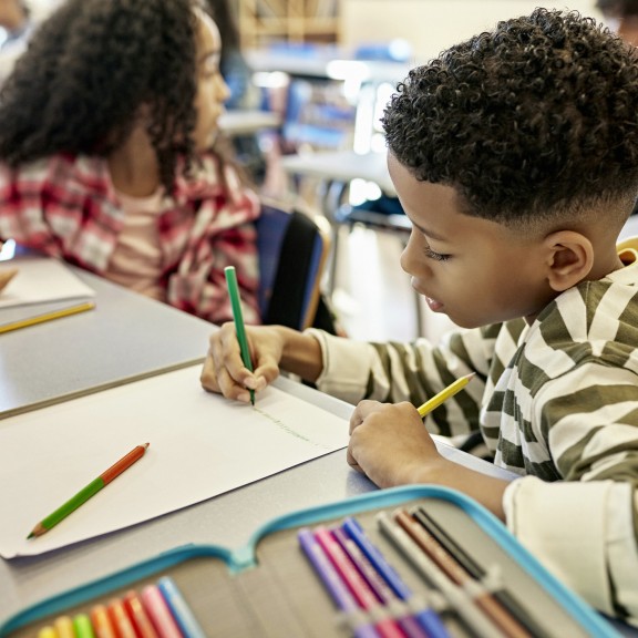 Student writing in class