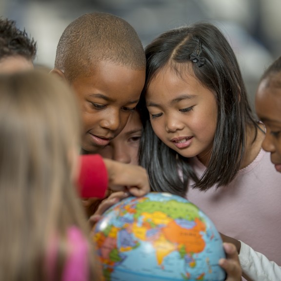 Students looking at globe