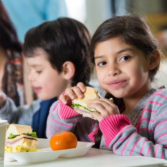 Young girl eating sandwich