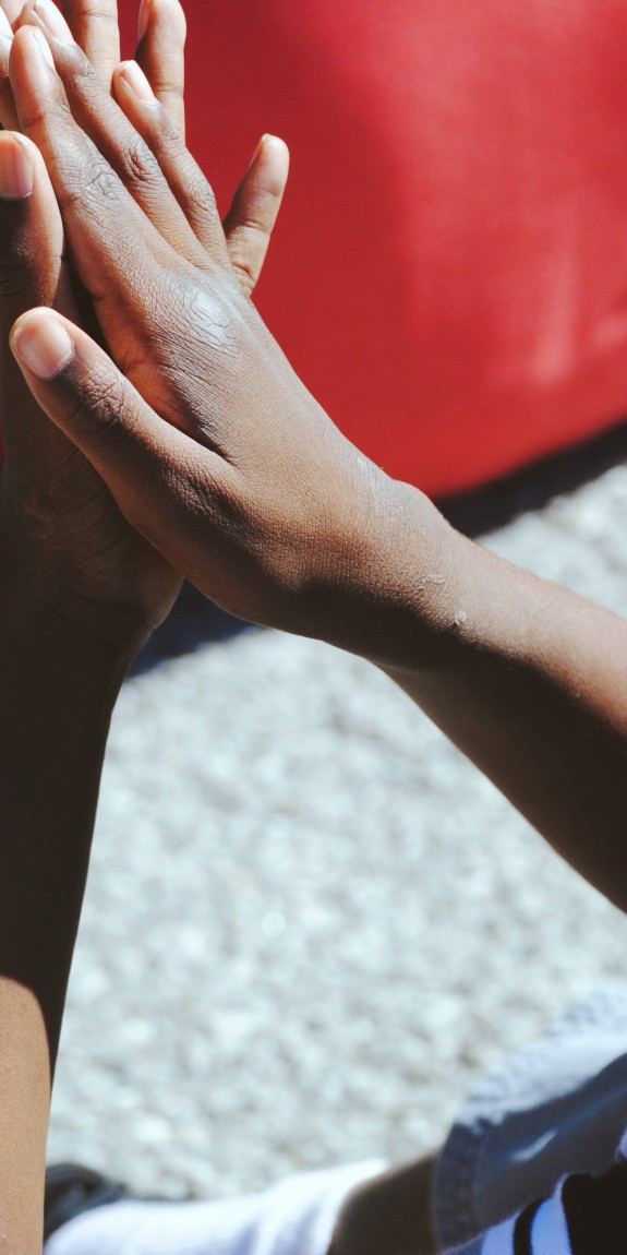 young person from behind side rubbing hands