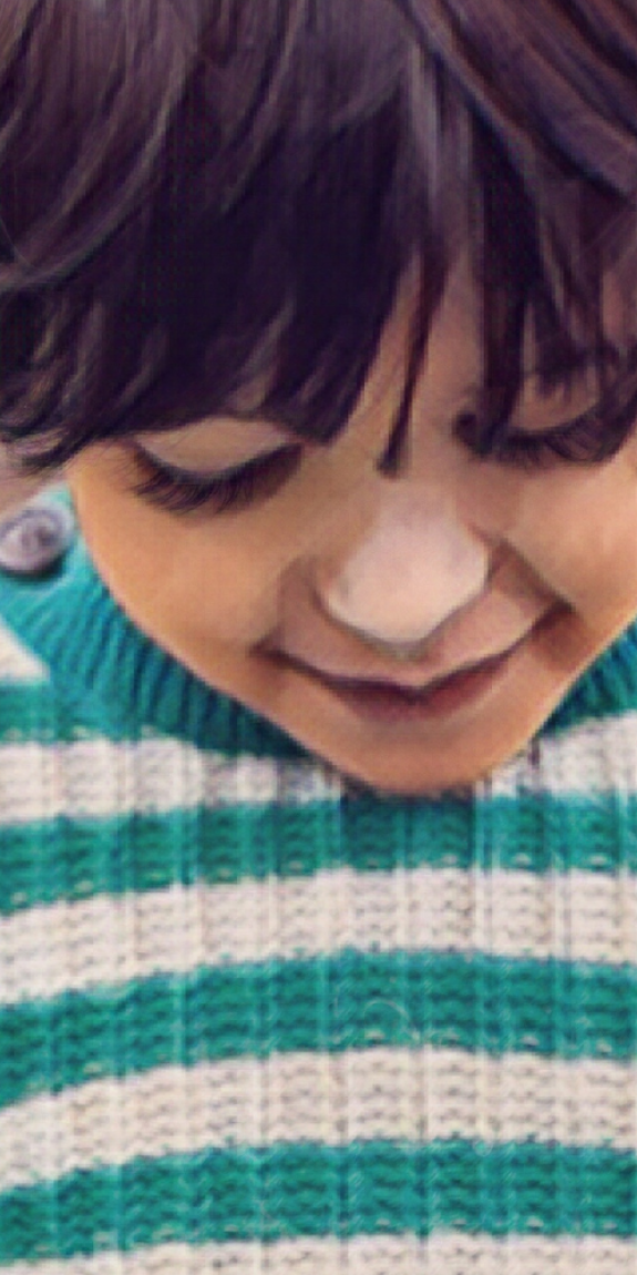Child in a sweater looking down