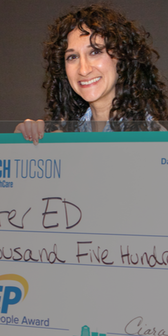 Jennie Hedges holding an enormous $7,500 check