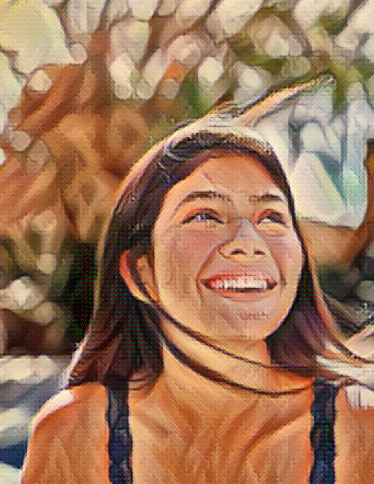 Young person smiling with hair blowing in the wind