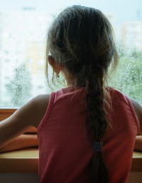 Child looks out a window