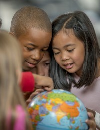 Students looking at globe