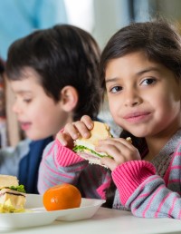 Young girl eating sandwich