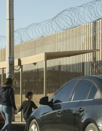 Mother and child walk near U.S.-Mexico border crossing