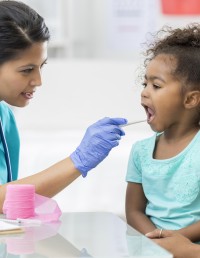 Pediatrician examines young patient