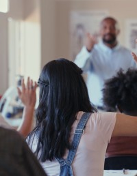 Students raising their hands in class