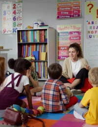 Students sitting with their teacher in class