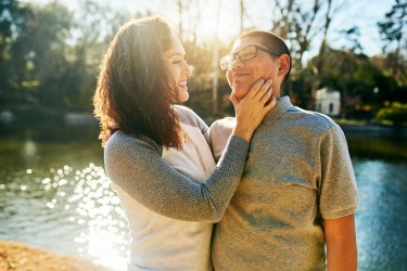 An adult looks lovingly at a teen