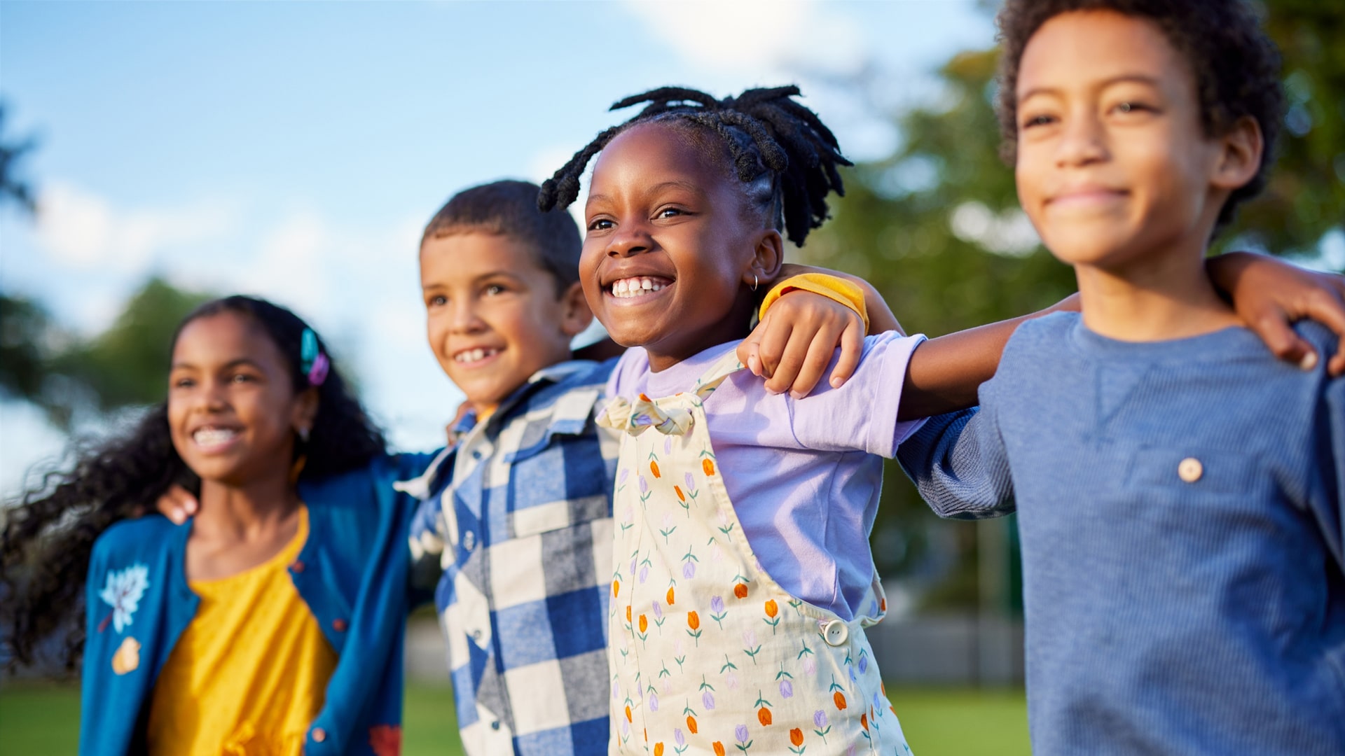 Diverse group of children smiling in the sun